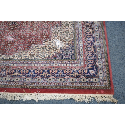 1305 - A LARGE 20TH CENTURY BIDJAR WOOL RUG, with red, cream and blue field, central medallion, and multi s... 