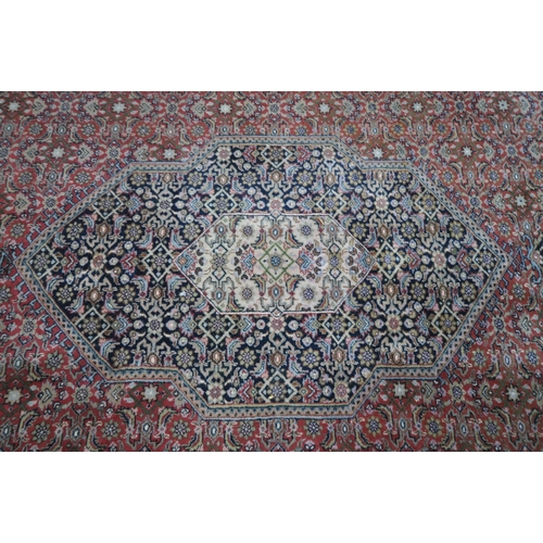 1305 - A LARGE 20TH CENTURY BIDJAR WOOL RUG, with red, cream and blue field, central medallion, and multi s... 