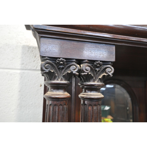 1307 - AN EDWARDIAN MAHOGANY MIRRORBACK SIDEBOARD, the top with an overhanging cornice, supported by pillar... 