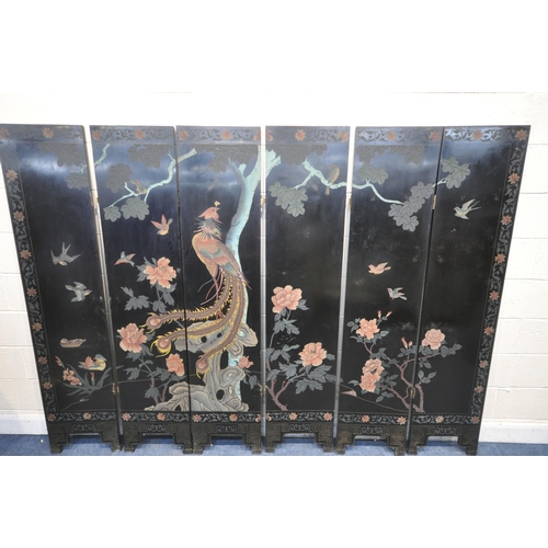 1322 - A BLACK LAQUERED ORIENTAL SIX FOLDING SCREEN, each side showing a different chinoiserie image, each ... 