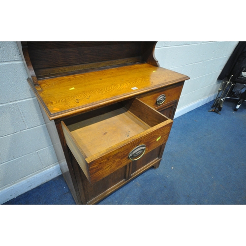 1333 - AN EARLY 20TH CENTURY OAK BOOKCASE, with double glazed doors, over a base with two drawers, and doub... 