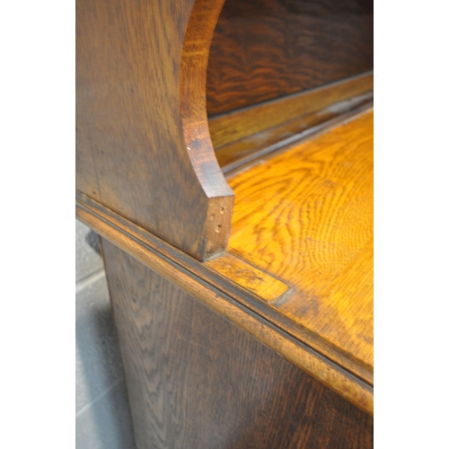 1333 - AN EARLY 20TH CENTURY OAK BOOKCASE, with double glazed doors, over a base with two drawers, and doub... 