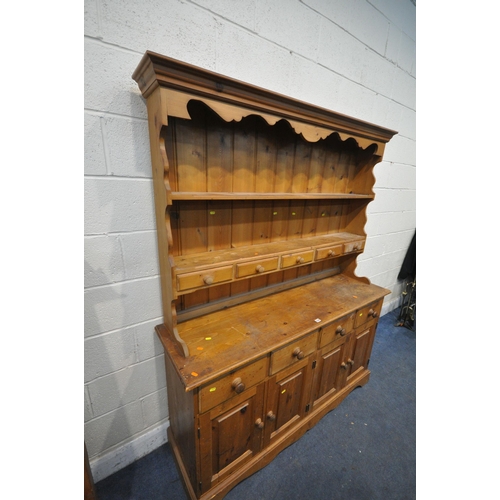 1335 - A PINE DRESSER, with two shelves, with five drawers, over a base with four drawers, width 152cm x de... 