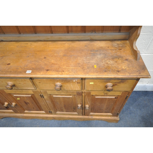 1335 - A PINE DRESSER, with two shelves, with five drawers, over a base with four drawers, width 152cm x de... 