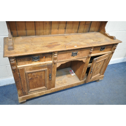 1336 - A 19TH CENTURY PINE DRESSER, the later top with arrangement of cupboards flanking open shelves, over... 