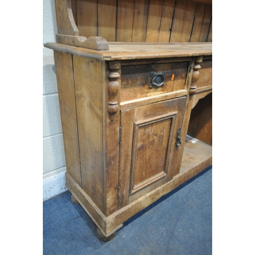 1336 - A 19TH CENTURY PINE DRESSER, the later top with arrangement of cupboards flanking open shelves, over... 