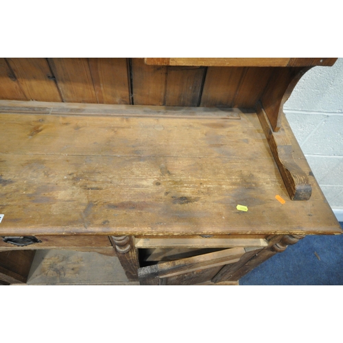 1336 - A 19TH CENTURY PINE DRESSER, the later top with arrangement of cupboards flanking open shelves, over... 