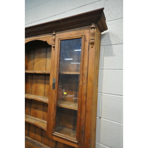 1336 - A 19TH CENTURY PINE DRESSER, the later top with arrangement of cupboards flanking open shelves, over... 