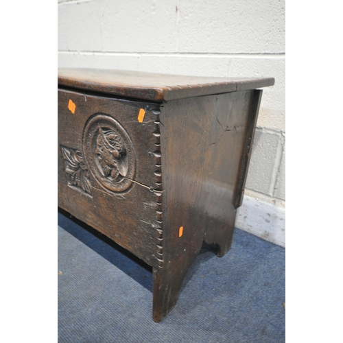 1337 - A 16TH/17TH CENTURY OAK SIX PLANK BOARDED CHEST, with a carved masks within a circle, and two foliag... 