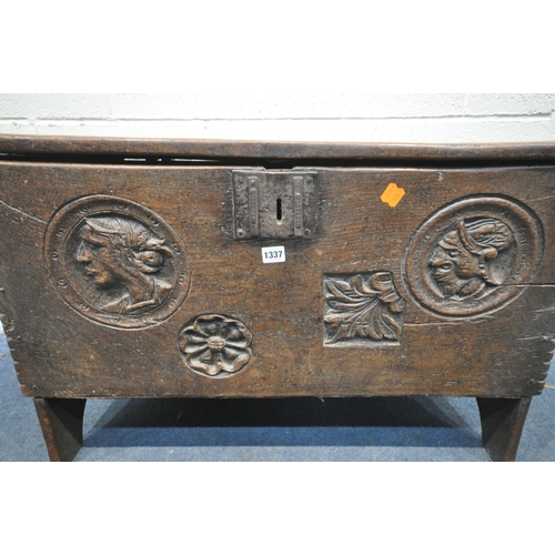 1337 - A 16TH/17TH CENTURY OAK SIX PLANK BOARDED CHEST, with a carved masks within a circle, and two foliag... 