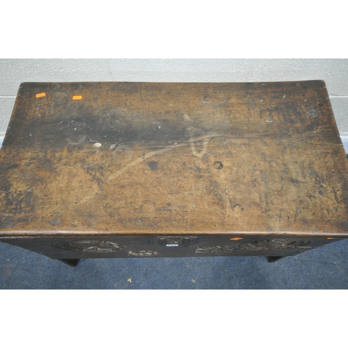 1337 - A 16TH/17TH CENTURY OAK SIX PLANK BOARDED CHEST, with a carved masks within a circle, and two foliag... 