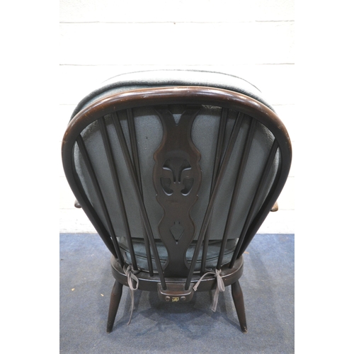 1344 - AN ERCOL MODEL 335 ARMCHAIR, with a Prince of Wales back, and loose cushions (condition report: worn... 