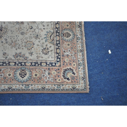 1345 - A LARGE WOOL CREAM AND PINK RUG, 306cm x 202cm (condition report: in need of cleaning, full of dog h... 