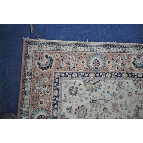 1345 - A LARGE WOOL CREAM AND PINK RUG, 306cm x 202cm (condition report: in need of cleaning, full of dog h... 