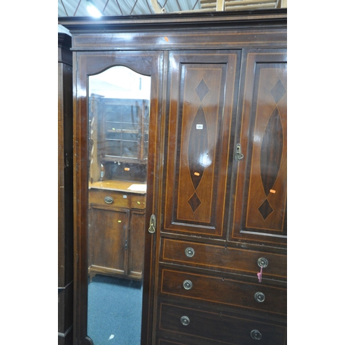 1351 - AN EDWARDIAN MAHOGANY COMPACTUM WARDROBE, with two mirrored doors, flanking two cupboard doors, abov... 