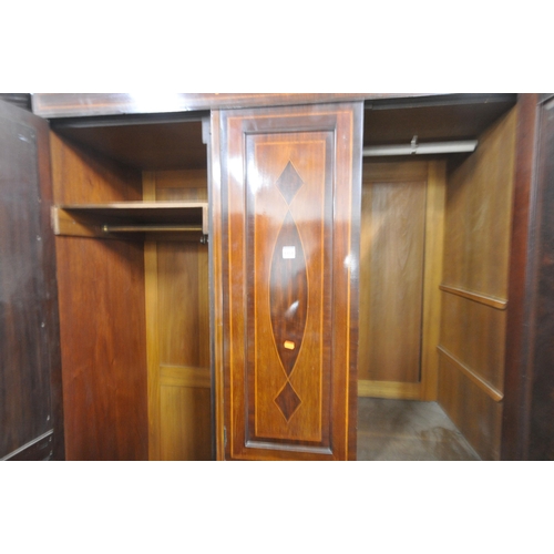 1351 - AN EDWARDIAN MAHOGANY COMPACTUM WARDROBE, with two mirrored doors, flanking two cupboard doors, abov... 