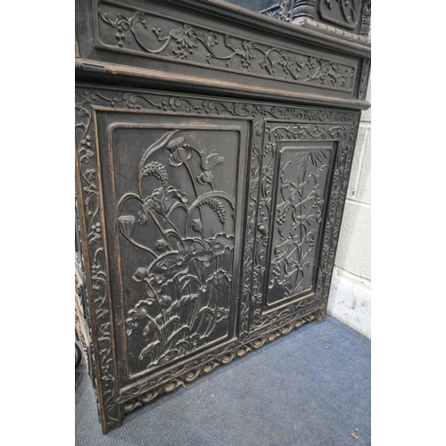 1353 - A 19TH CENTURY EBONISED ROSEWOOD CHINESE BOOKCASE ABOVE DESK, heavily carved throughout with dragons... 