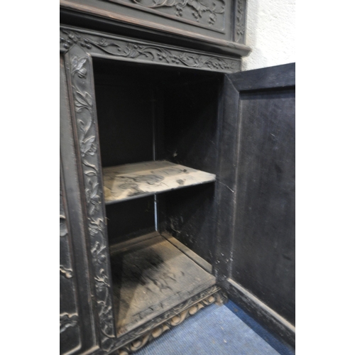 1353 - A 19TH CENTURY EBONISED ROSEWOOD CHINESE BOOKCASE ABOVE DESK, heavily carved throughout with dragons... 