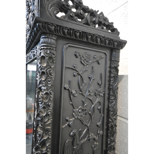 1353 - A 19TH CENTURY EBONISED ROSEWOOD CHINESE BOOKCASE ABOVE DESK, heavily carved throughout with dragons... 