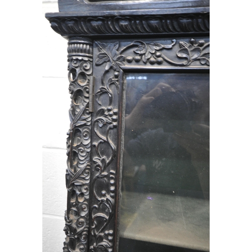 1353 - A 19TH CENTURY EBONISED ROSEWOOD CHINESE BOOKCASE ABOVE DESK, heavily carved throughout with dragons... 