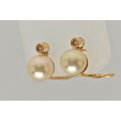 28 - A PAIR OF IMITATION PEARL AND DIAMOND EARRINGS, each designed as a brilliant cut diamond above an im... 