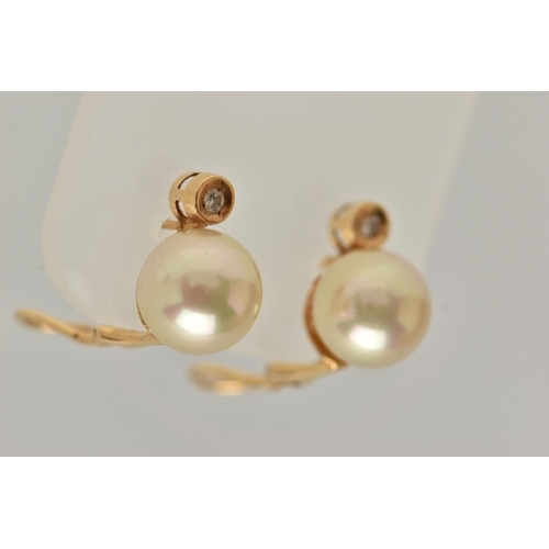 28 - A PAIR OF IMITATION PEARL AND DIAMOND EARRINGS, each designed as a brilliant cut diamond above an im... 