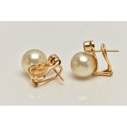 28 - A PAIR OF IMITATION PEARL AND DIAMOND EARRINGS, each designed as a brilliant cut diamond above an im... 