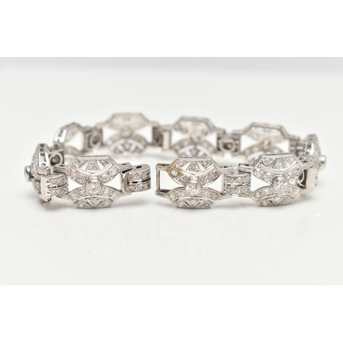 33 - AN ART DECO STYLE DIAMOND BRACELET, nine white metal panels, each set with a single bezel set round ... 