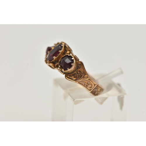 42 - A LATE 19TH CENTURY 9CT GOLD THREE STONE RING, central oval cut garnet set with two oval cut red pas... 