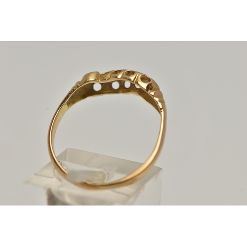 47 - A YELLOW METAL DIAMOND RING, set with five graduated diamonds, within a scroll mount, leading onto a... 