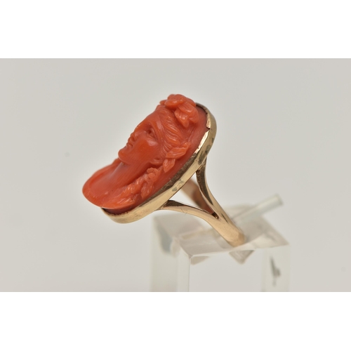 60 - A CARVED CORAL RING, a cameo ring depicting a lady with flowers in her hair, collect set in rose met... 