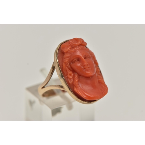 60 - A CARVED CORAL RING, a cameo ring depicting a lady with flowers in her hair, collect set in rose met... 