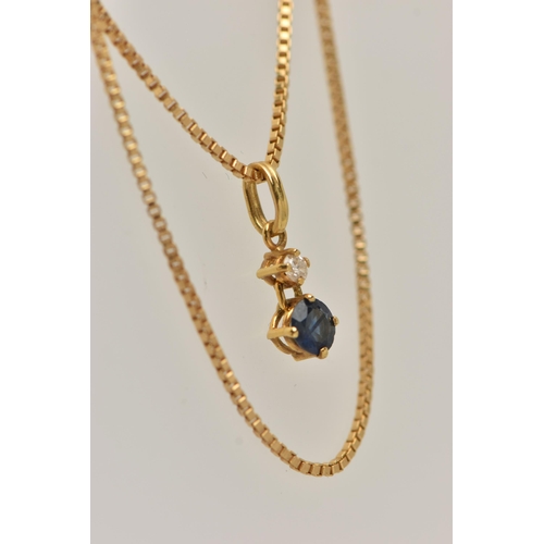 63 - AN 18CT GOLD TWO STONE PENDANT, a round brilliant cut diamond and a circular cut sapphire prong set ... 