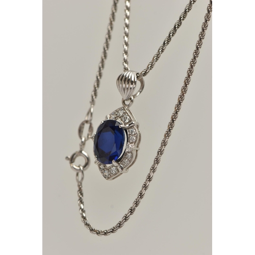 80 - A WHITE METAL PENDANT NECKLACE, the pendant set with an oval cut synthetic blue sapphire in a surrou... 