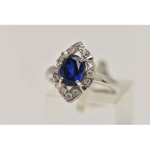 81 - A WHITE METAL RING AND EARRINGS, the ring of a marquise shape, set with an oval cut synthetic blue s... 