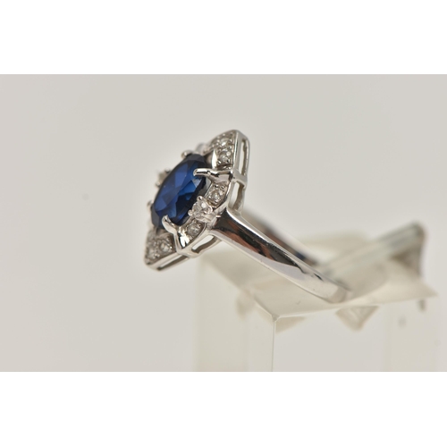 81 - A WHITE METAL RING AND EARRINGS, the ring of a marquise shape, set with an oval cut synthetic blue s... 