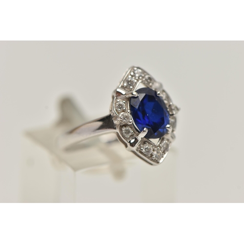 81 - A WHITE METAL RING AND EARRINGS, the ring of a marquise shape, set with an oval cut synthetic blue s... 