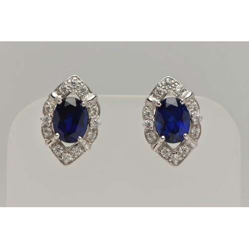 81 - A WHITE METAL RING AND EARRINGS, the ring of a marquise shape, set with an oval cut synthetic blue s... 