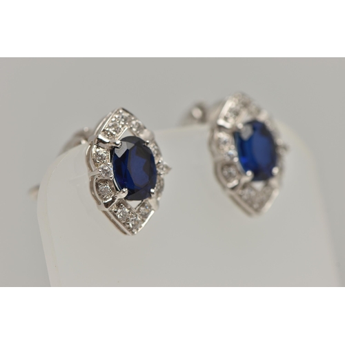 81 - A WHITE METAL RING AND EARRINGS, the ring of a marquise shape, set with an oval cut synthetic blue s... 