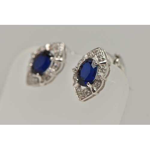 81 - A WHITE METAL RING AND EARRINGS, the ring of a marquise shape, set with an oval cut synthetic blue s... 