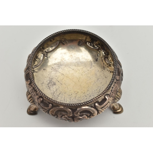 102 - A VICTORIAN SILVER CIRCULAR OPEN SALT, repoussé decorated with flowers and scrolls, on three cabriol... 