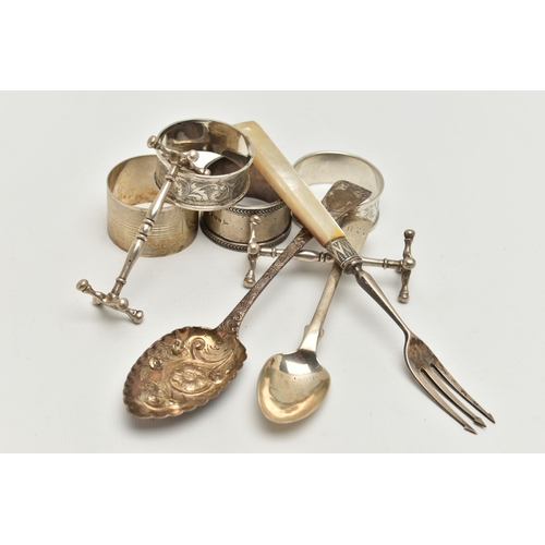 130 - A BAG OF ASSORTED SILVER ITEMS, to include a pair of silver knife rests, hallmarked Chester, an embo... 