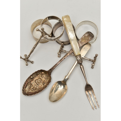 130 - A BAG OF ASSORTED SILVER ITEMS, to include a pair of silver knife rests, hallmarked Chester, an embo... 