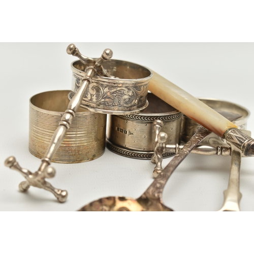 130 - A BAG OF ASSORTED SILVER ITEMS, to include a pair of silver knife rests, hallmarked Chester, an embo... 