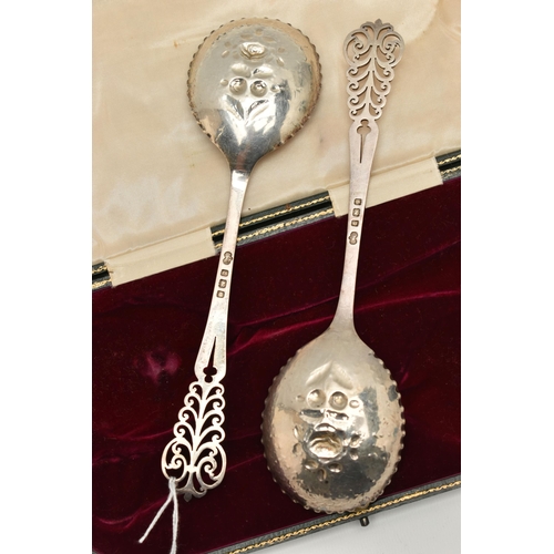 143 - A CASED PAIR OF EDWARDIAN ELKINGTON & CO SILVER FRUIT SPOONS, gilt circular bowls chased and repouss... 