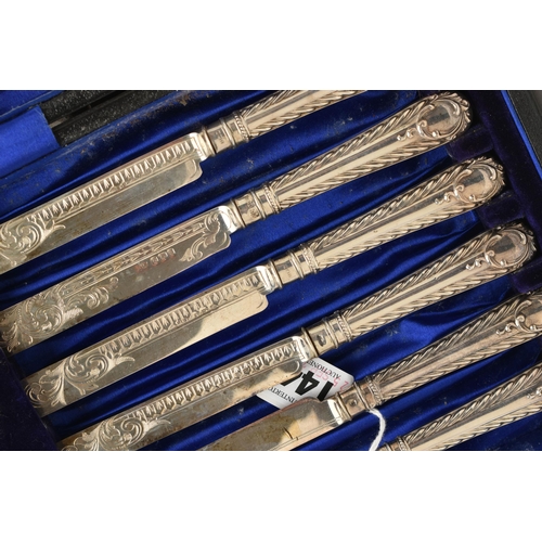 144 - A CASED SET OF SIX EDWARDIAN SILVER DESSERT KNIVES AND FORKS. the handles with a feathered pattern a... 