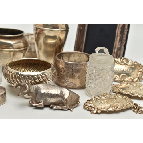 150 - AN ASSORTED BOX OF SILVER ITEMS, to include three napkin rings, salt and pepper shakers, three decan... 