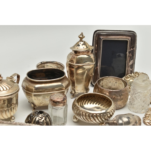 150 - AN ASSORTED BOX OF SILVER ITEMS, to include three napkin rings, salt and pepper shakers, three decan... 