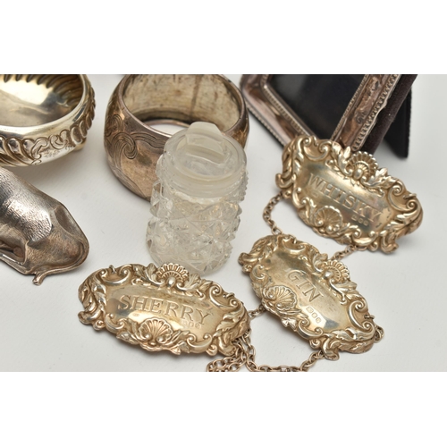 150 - AN ASSORTED BOX OF SILVER ITEMS, to include three napkin rings, salt and pepper shakers, three decan... 