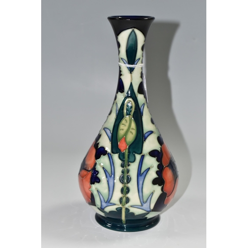 346 - A 1996 MOORCROFT POTTERY  BALUSTER VASE, 'Poppy' pattern on a dark blue ground, designed by Rachel B... 